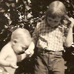 A girl holding a baby's hand