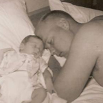 Guy and a baby sleeping together